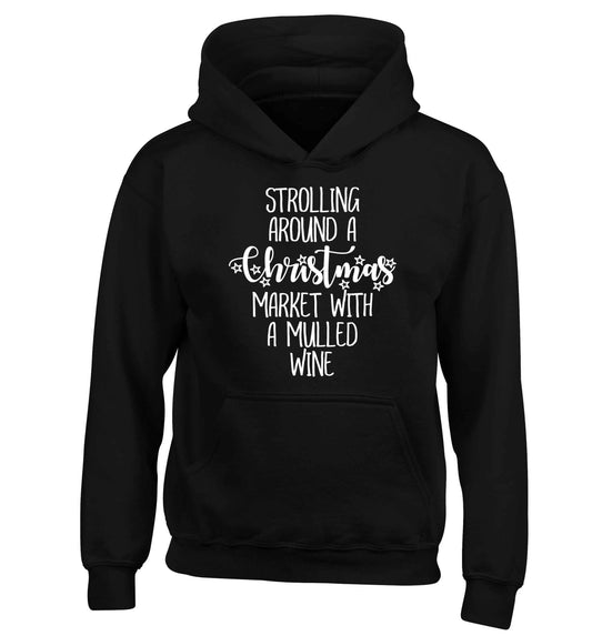 Strolling around a Christmas market with mulled wine children's black hoodie 12-13 Years