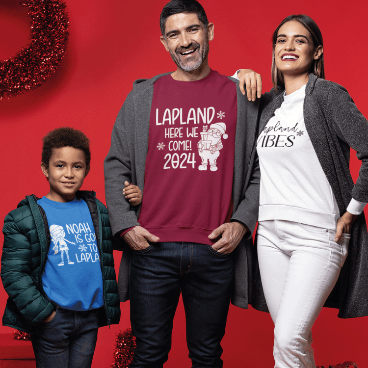 A son, mum and dad all wearing Christmas Lapland Jumpers