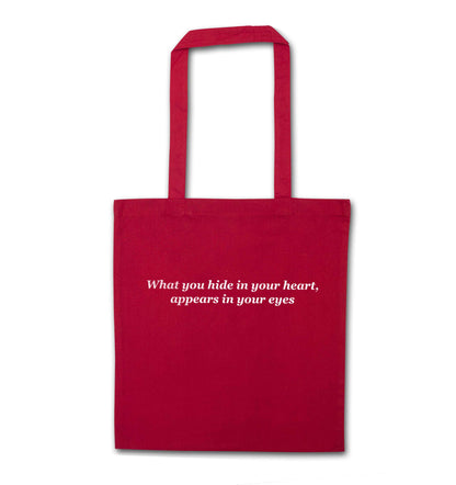 What you hide in your heart, appears in your eyes red tote bag