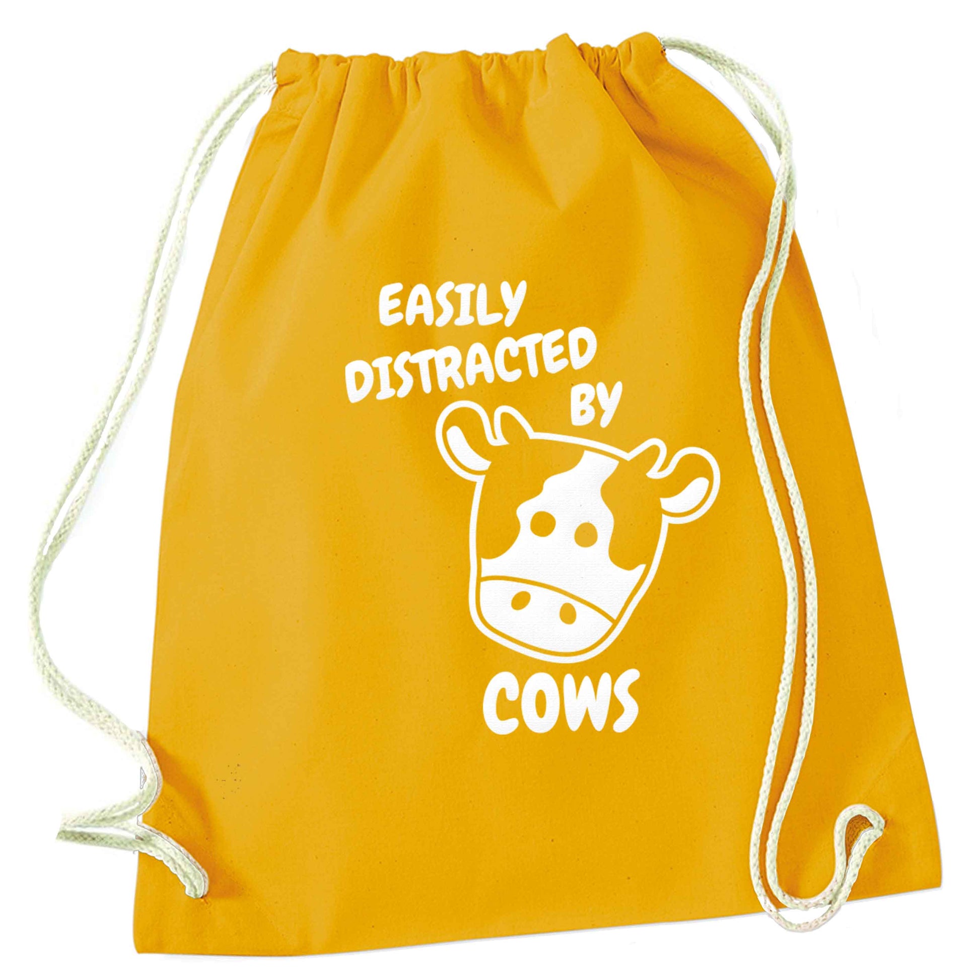 Easily distracted by cows mustard drawstring bag