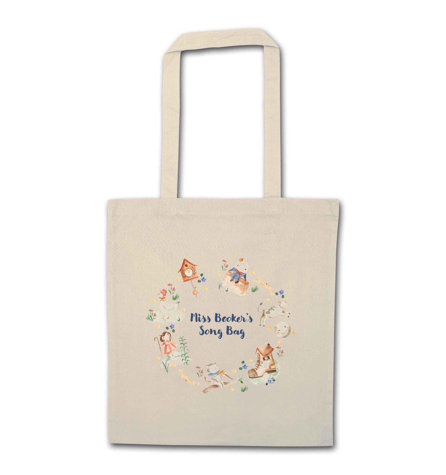 Image shows a cream coloured tote bag. Printed on the bag is some colourful illustrations from nursery rhymes, humpty dumpty, little bo peep, a clock, a boot, a goos, a cat and the fiddle and a cow and a moon. The watercolour illustrations are arranged in a wreath shape with the words 'Grace's son bang' written in blue in the middle.