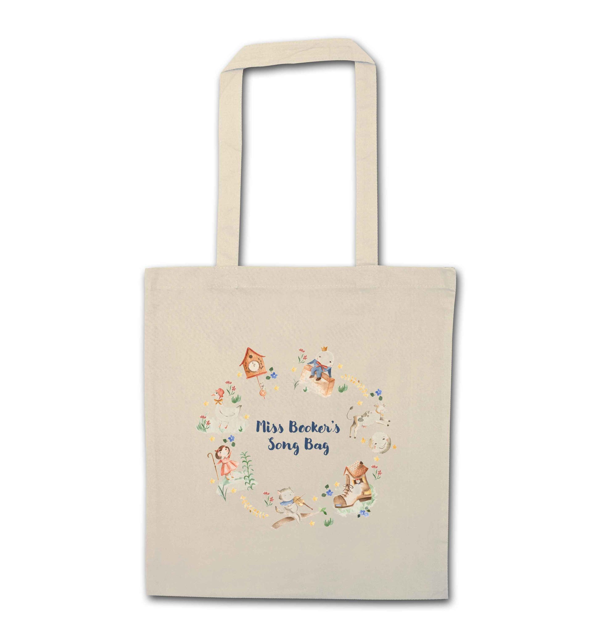 Image shows a cream coloured tote bag. Printed on the bag is some colourful illustrations from nursery rhymes, humpty dumpty, little bo peep, a clock, a boot, a goos, a cat and the fiddle and a cow and a moon. The watercolour illustrations are arranged in a wreath shape with the words 'Grace's son bang' written in blue in the middle.