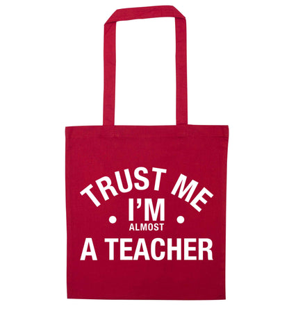 Trust me I'm almost a teacher red tote bag