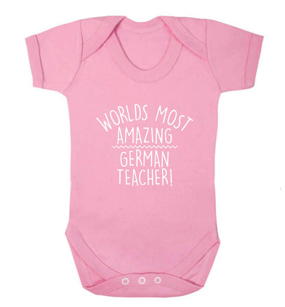 Worlds most amazing German teacher baby vest pale pink 18-24 months