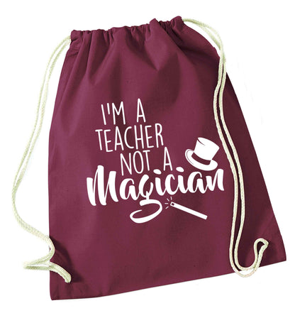 I'm a teacher not a magician maroon drawstring bag