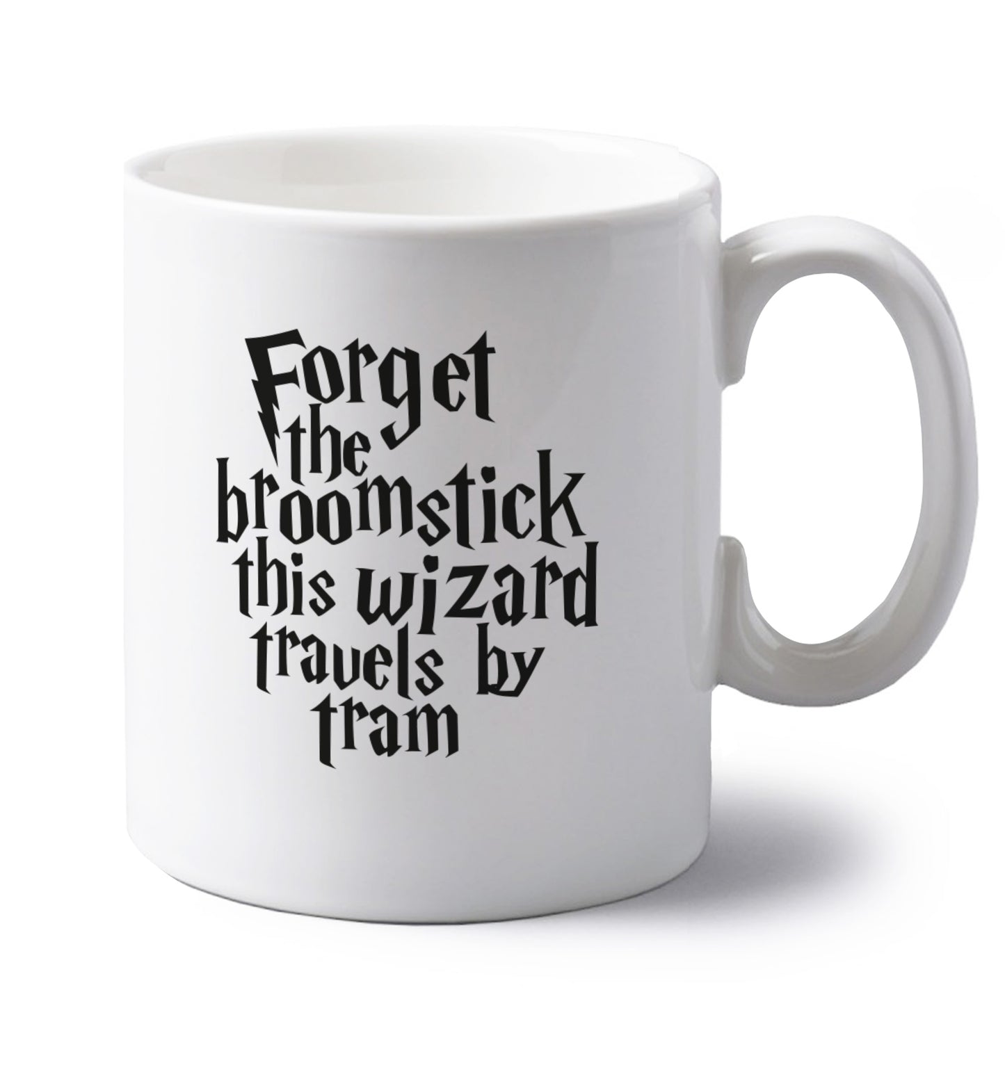 Forget the broomstick this wizard travels by tram left handed white ceramic mug 