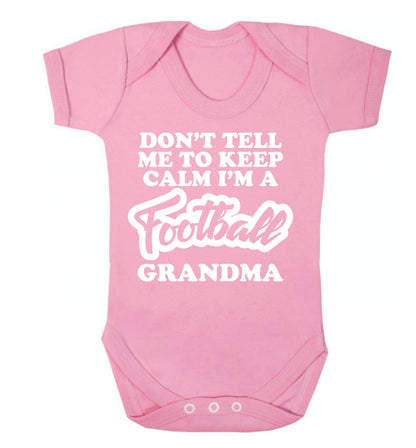 Don't tell me to keep calm I'm a football grandma Baby Vest pale pink 18-24 months