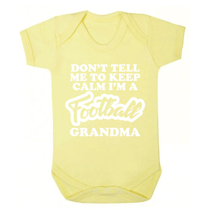 Don't tell me to keep calm I'm a football grandma Baby Vest pale yellow 18-24 months