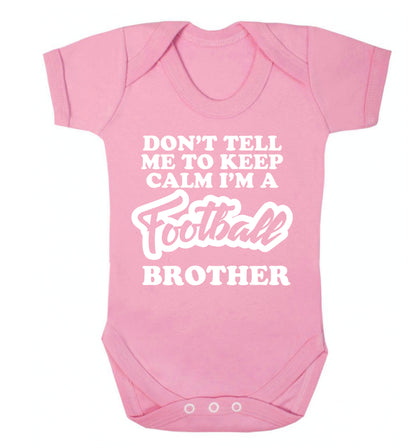 Don't tell me to keep calm I'm a football brother Baby Vest pale pink 18-24 months