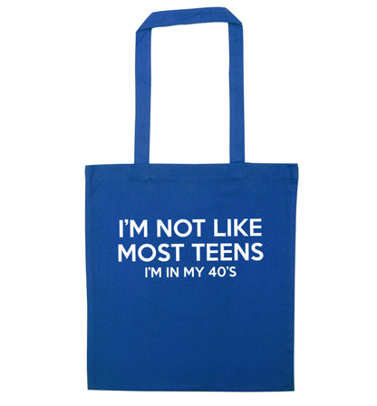 I'm not like most teens (I'm in my 40's) blue tote bag