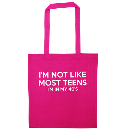 I'm not like most teens (I'm in my 40's) pink tote bag