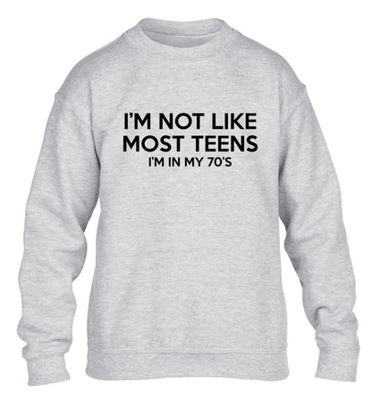 I'm not like most teens (I'm in my 70's) children's grey sweater 12-13 Years