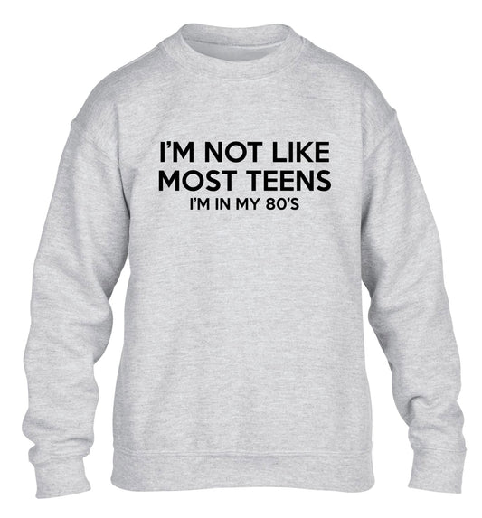 I'm not like most teens (I'm in my 80's) children's grey sweater 12-13 Years
