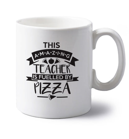 This amazing teacher is fuelled by pizza left handed white ceramic mug 