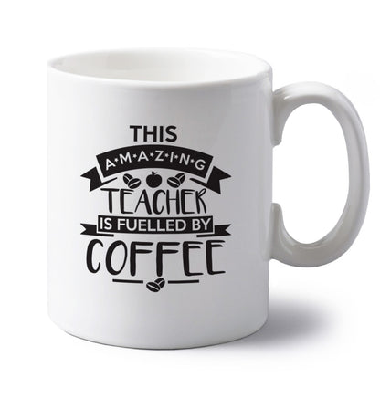 This amazing teacher is fuelled by coffee left handed white ceramic mug 