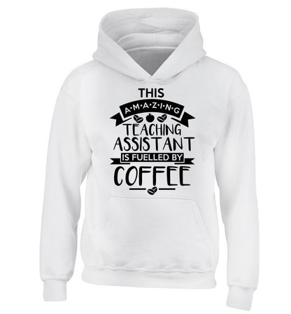 This amazing teaching assistant is fuelled by coffee children's white hoodie 12-13 Years