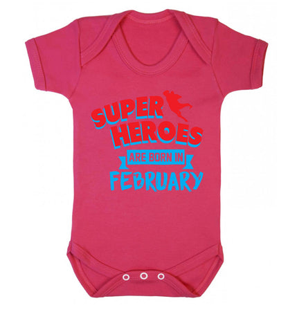 superheroes are born in February Baby Vest dark pink 18-24 months