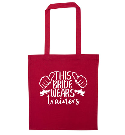 This bride wears trainers red tote bag