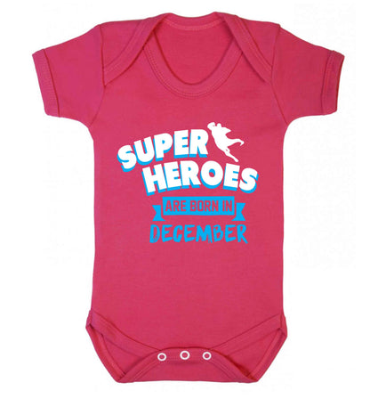 Superheroes are born in December Baby Vest dark pink 18-24 months