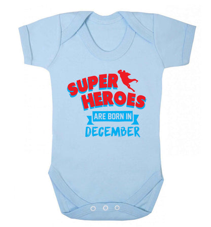 Superheroes are born in December Baby Vest pale blue 18-24 months