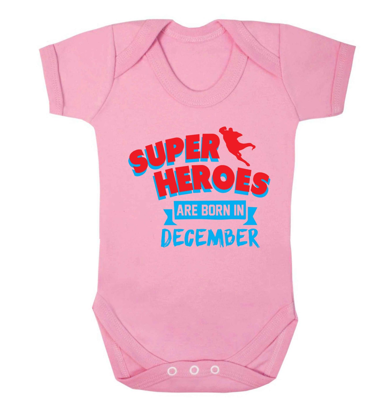 Superheroes are born in December Baby Vest pale pink 18-24 months
