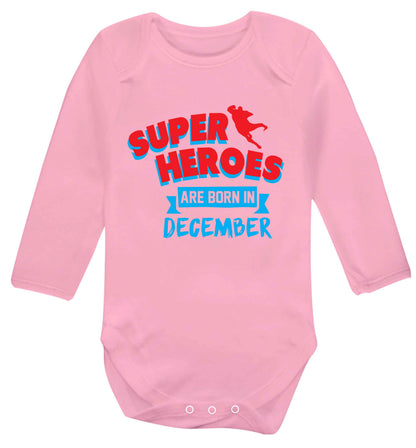 Superheroes are born in December Baby Vest long sleeved pale pink 6-12 months