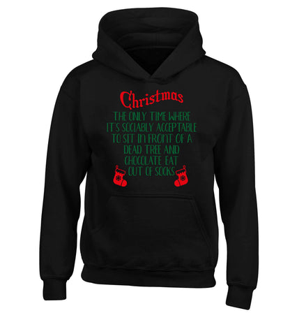Christmas sit in front of a dead tree and eat chocolate out of socks children's black hoodie 12-13 Years