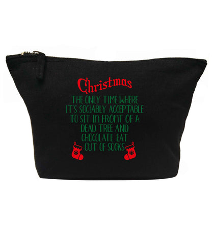 Christmas sit in front of a dead tree and eat chocolate out of socks | makeup / wash bag