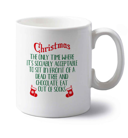Christmas sit in front of a dead tree and eat chocolate out of socks left handed white ceramic mug 