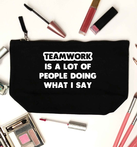 Teamwork is a lot of people doing what I say black makeup bag