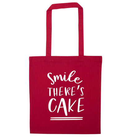 Smile there's cake red tote bag
