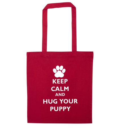 Keep calm and hug your puppy red tote bag