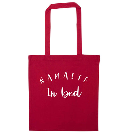 Namaste in bed red tote bag