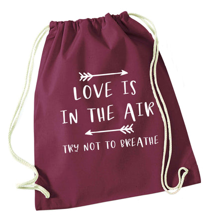 Love is in the air try not to breathe maroon drawstring bag