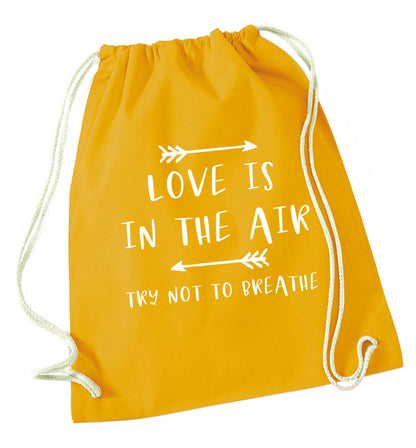 Love is in the air try not to breathe mustard drawstring bag