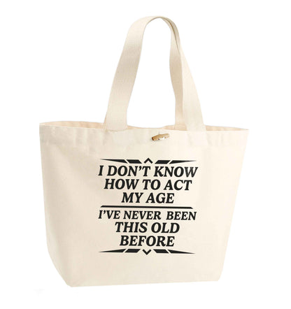 I don't know how to act my age I've never been this old before organic cotton premium tote bag with wooden toggle in natural