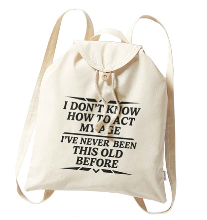 I don't know how to act my age I've never been this old before organic cotton backpack tote with wooden buttons in natural