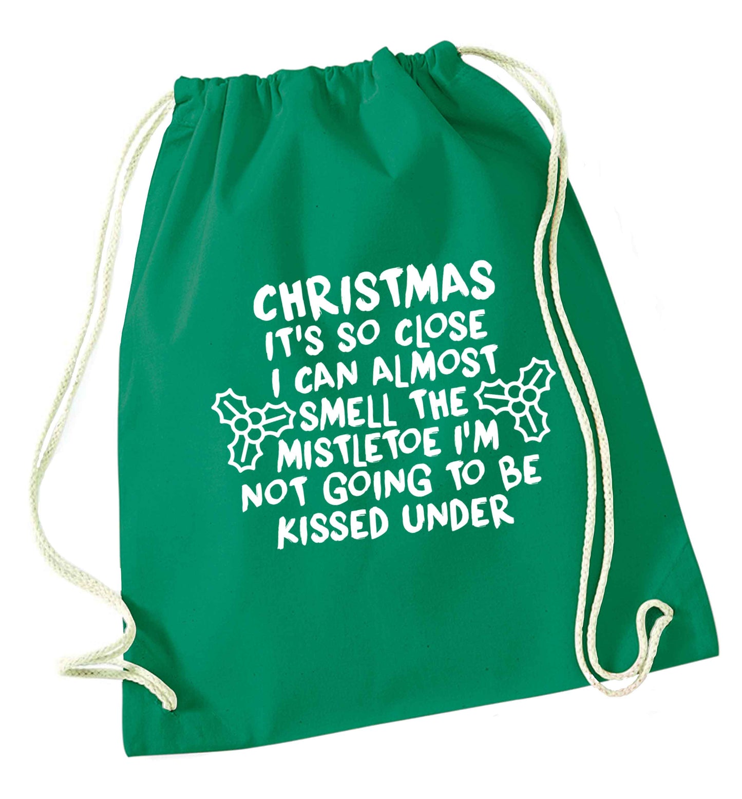 Christmas it's so close I can almost smell the misteltoe I'm not going to be kissed under green drawstring bag