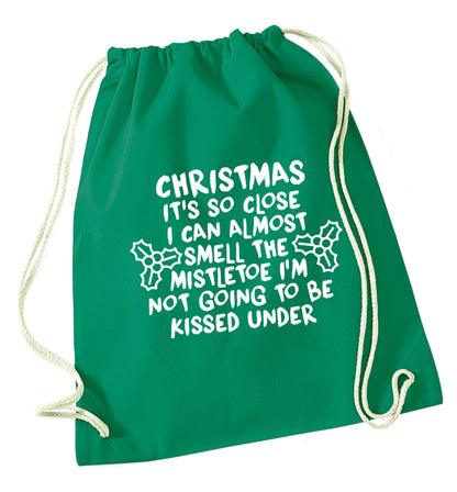 Christmas it's so close I can almost smell the misteltoe I'm not going to be kissed under green drawstring bag