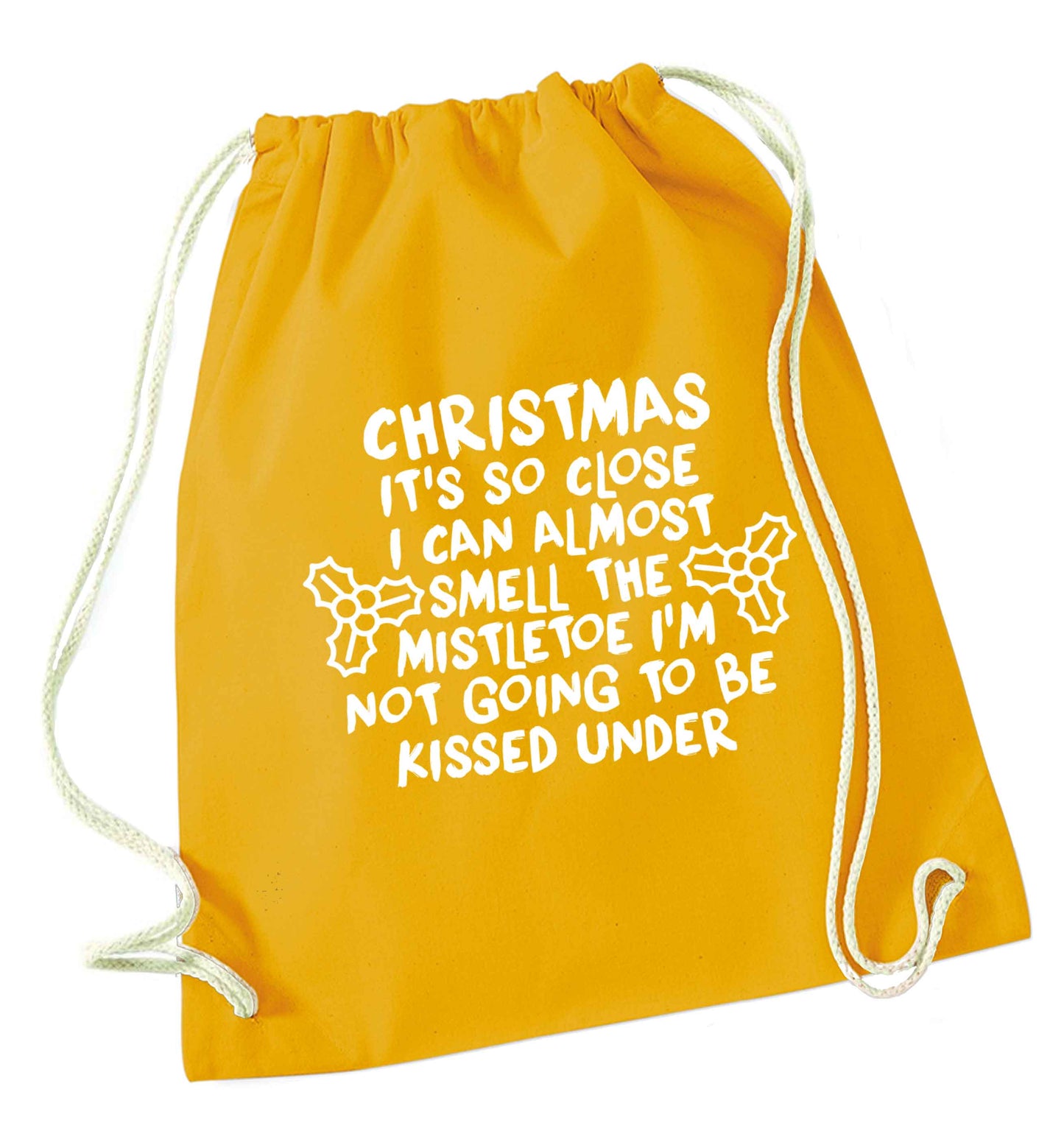 Christmas it's so close I can almost smell the misteltoe I'm not going to be kissed under mustard drawstring bag