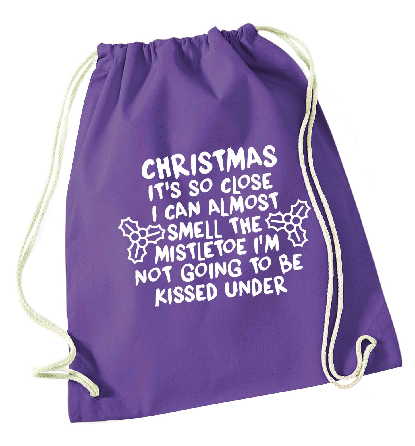 Christmas it's so close I can almost smell the misteltoe I'm not going to be kissed under purple drawstring bag