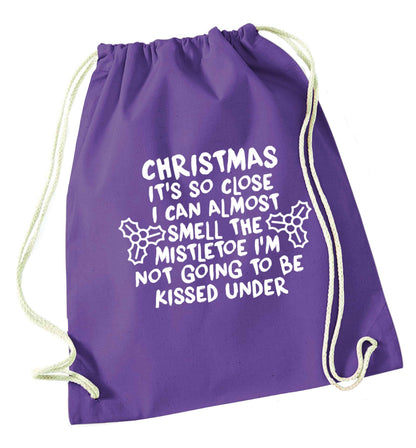 Christmas it's so close I can almost smell the misteltoe I'm not going to be kissed under purple drawstring bag
