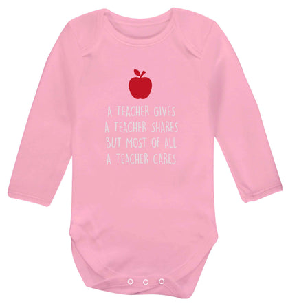 A teacher gives a teacher shares but most of all a teacher cares baby vest long sleeved pale pink 6-12 months